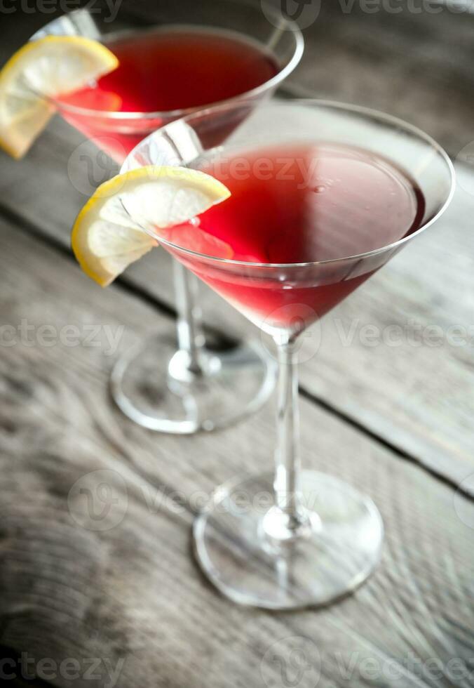 Two cosmopolitan cocktails on the wooden background photo