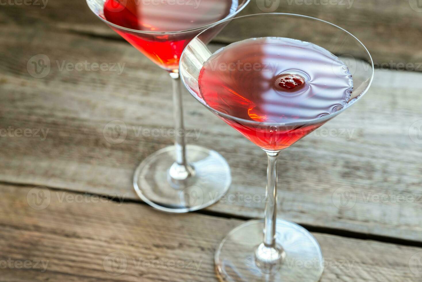 Two cosmopolitan cocktails on the wooden background photo