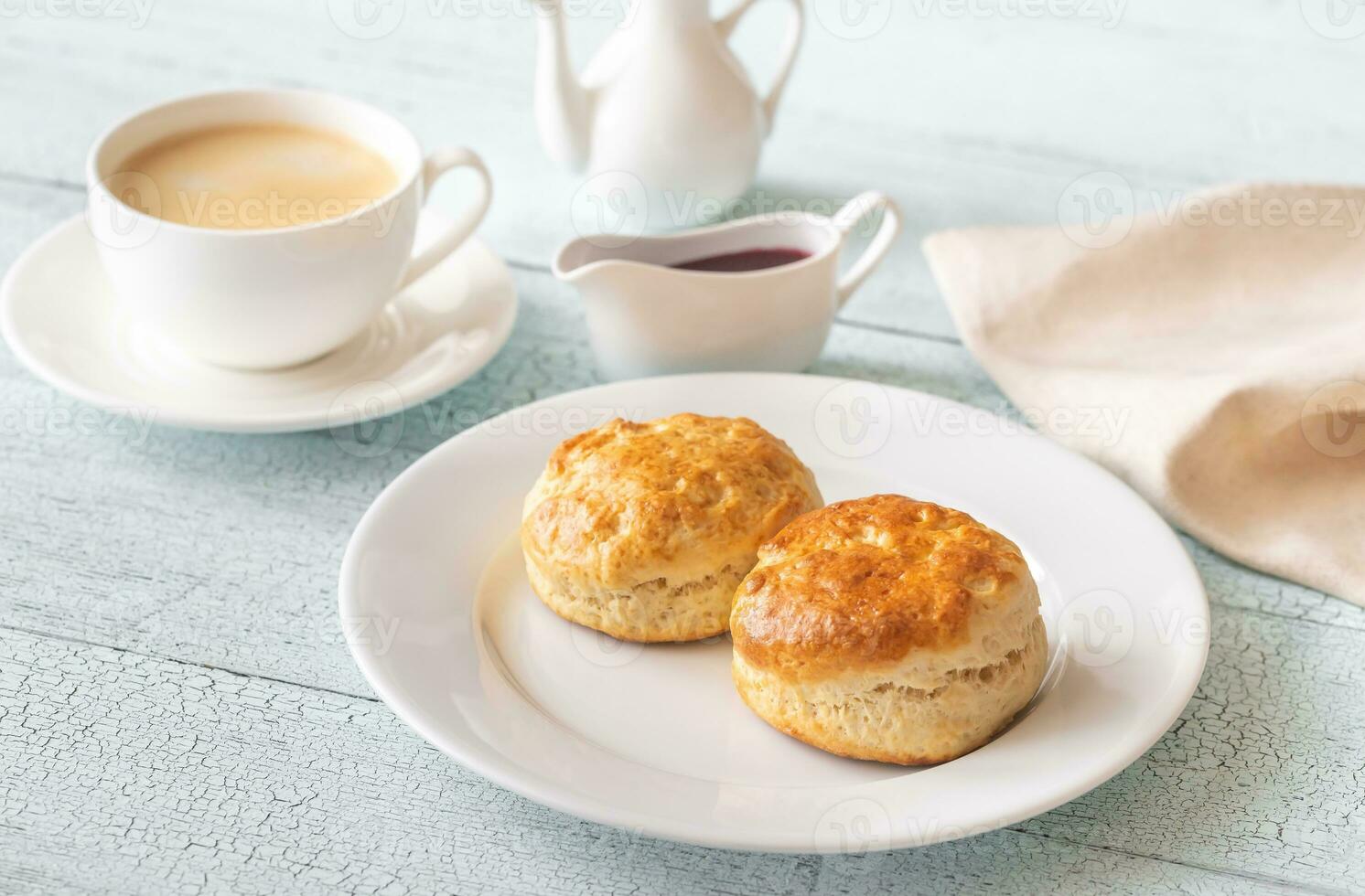 Classic scones with cream and berry jam photo