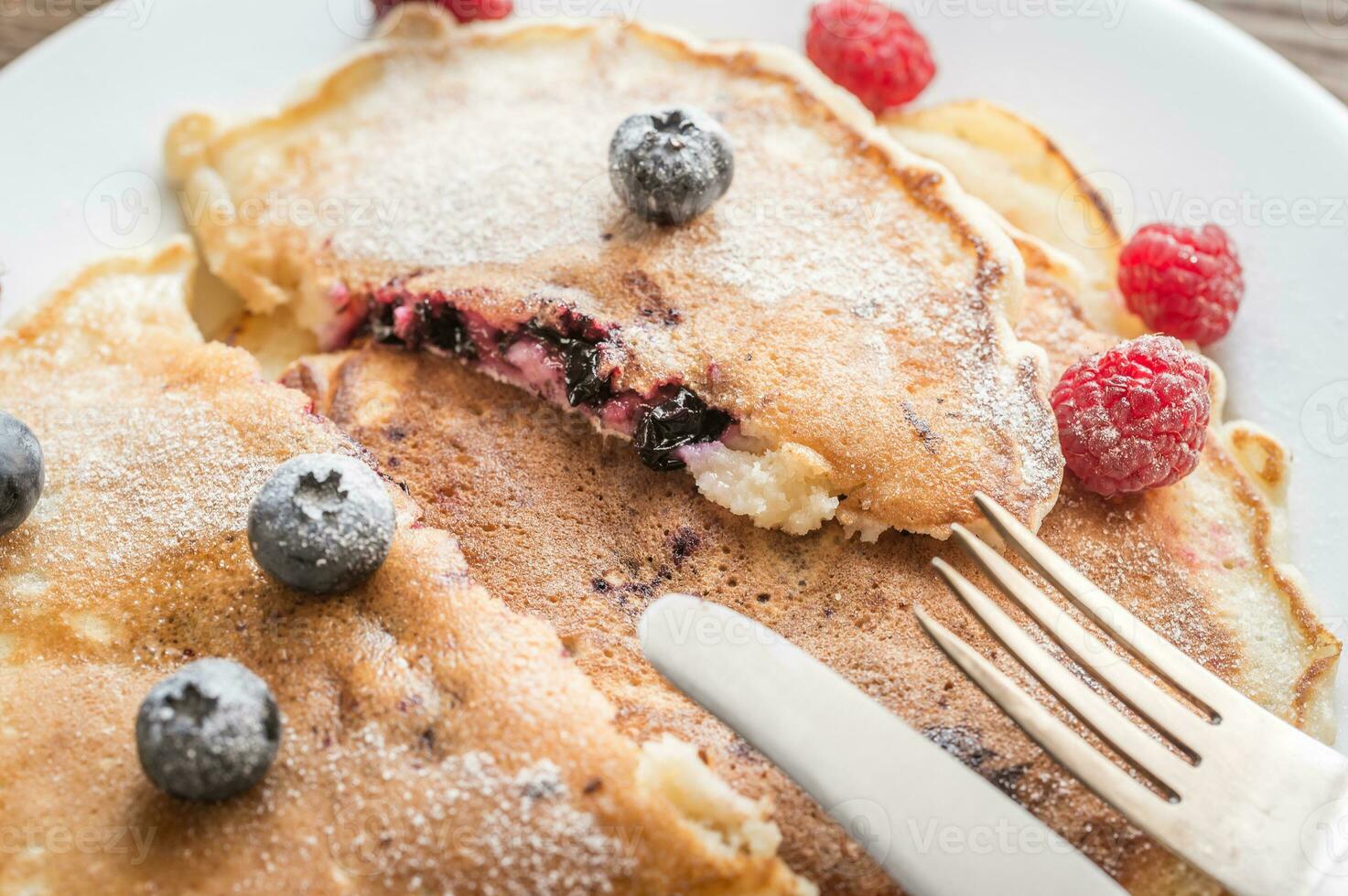 Pancakes with maple syrup and fresh berries photo