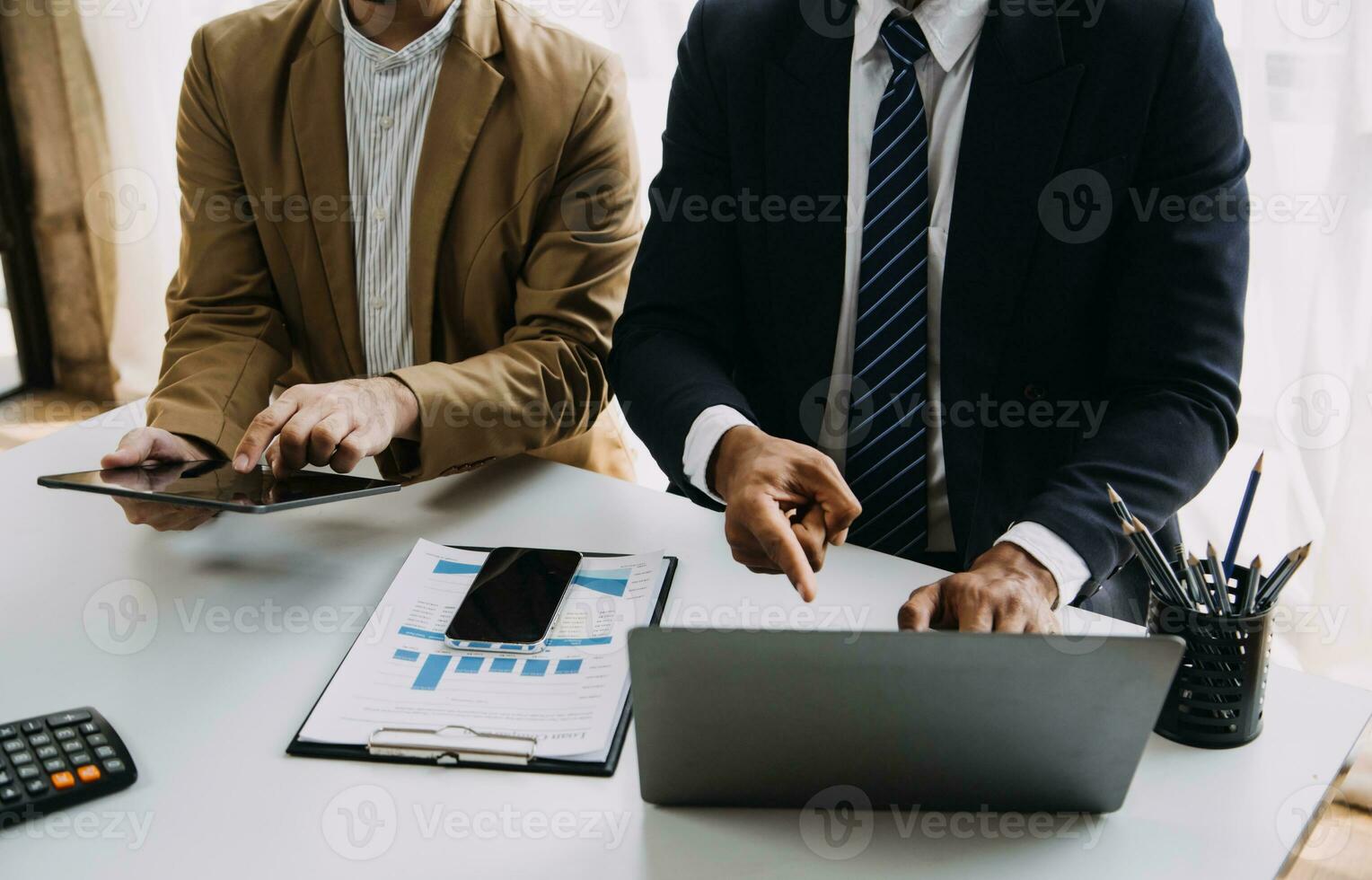 Businessman working on a laptop computer to document management online documentation database digital file storage system software records keeping database technology file access doc sharing. photo