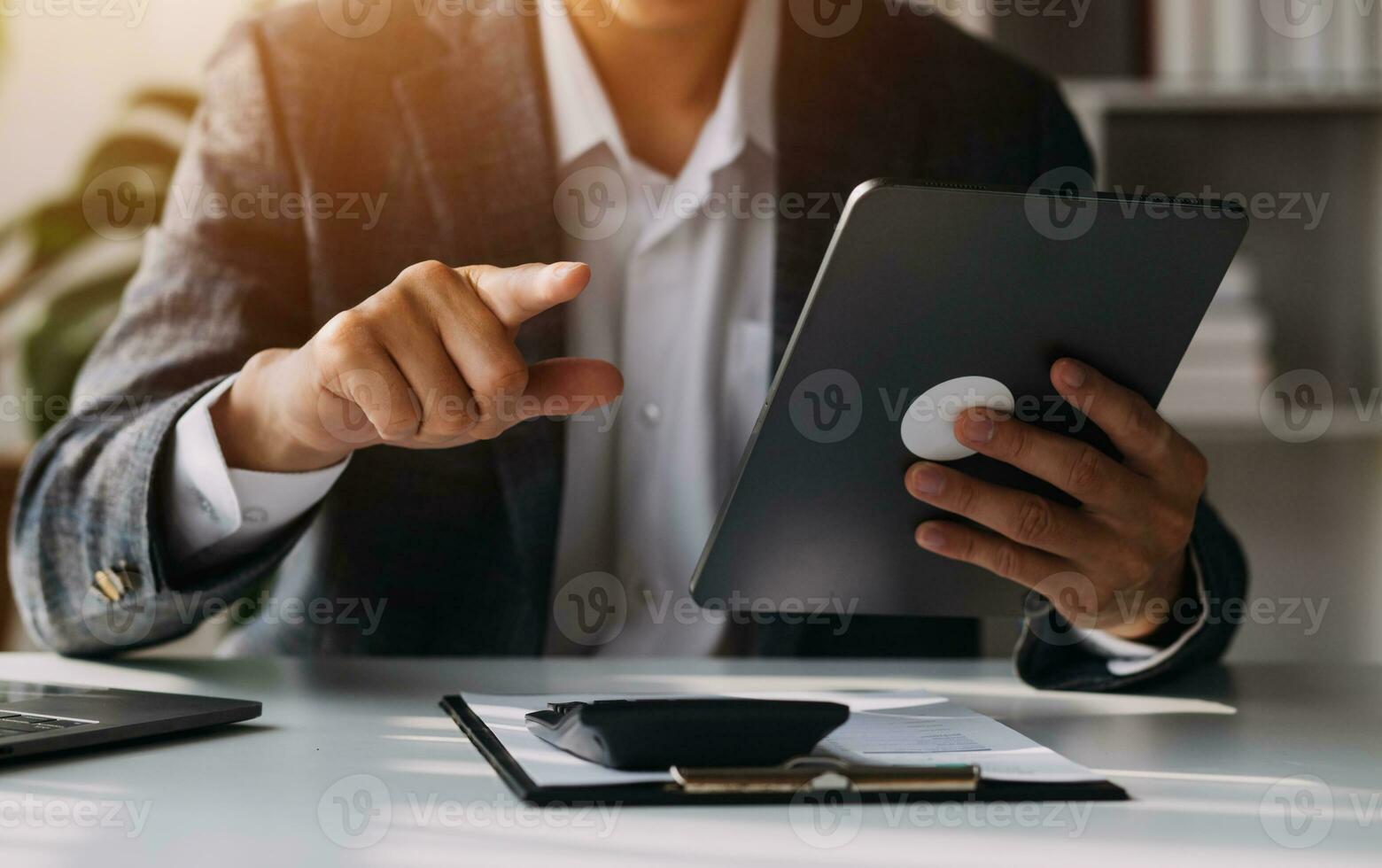 Businessman working on a laptop computer to document management online documentation database digital file storage system software records keeping database technology file access doc sharing. photo
