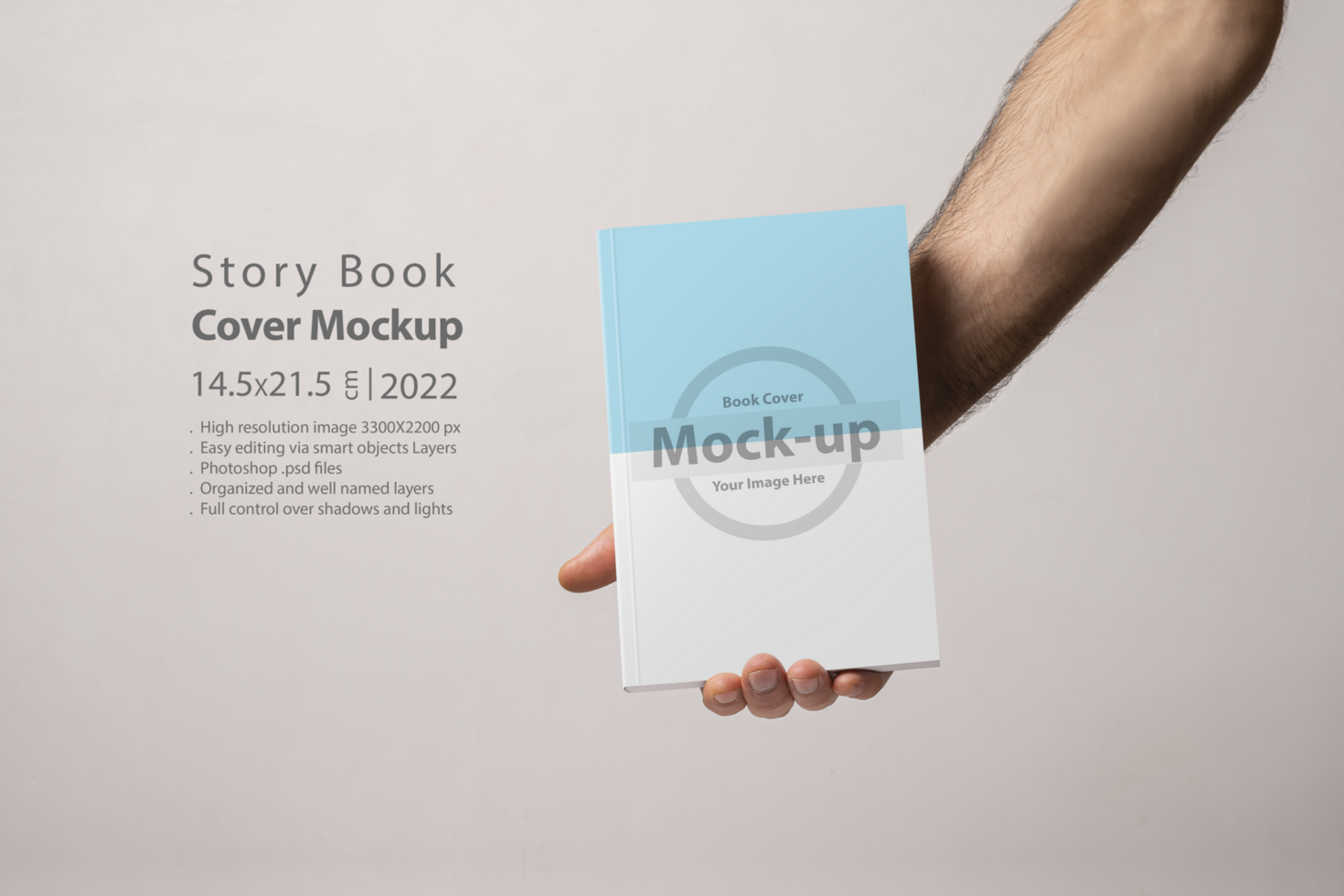Male hand holding a closed book-catalog with blank cover psd