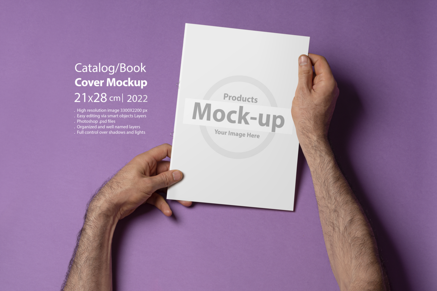 Male hands holding a catalog with blank cover on purple background psd