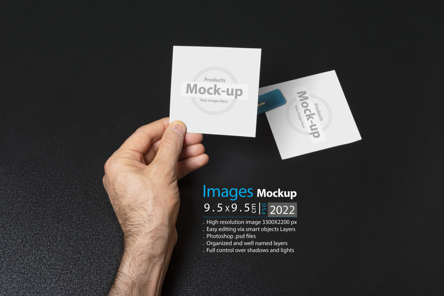hand holding a blank note paper or image frame on dark background psd