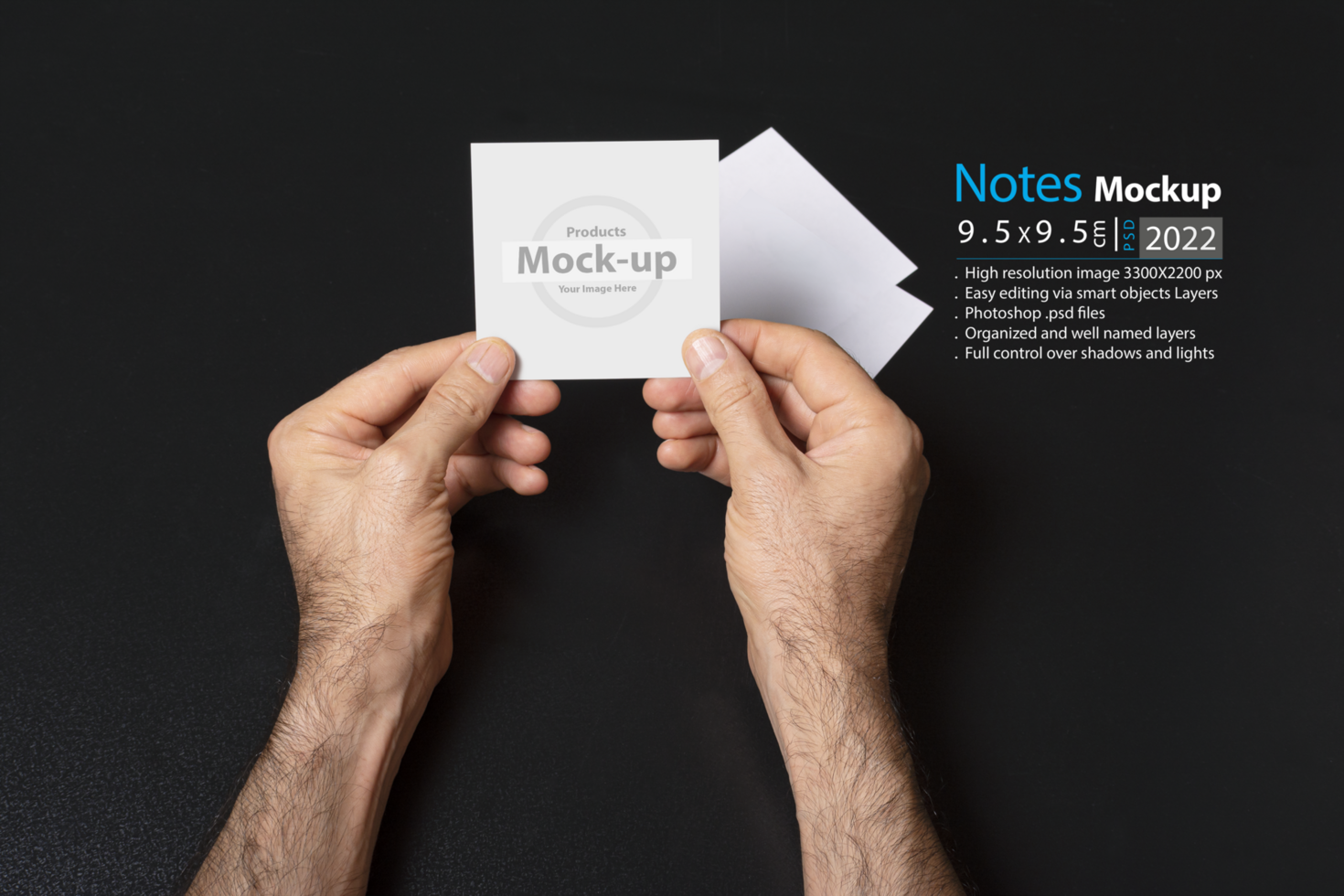hand holding a blank note paper or image frame on dark background psd