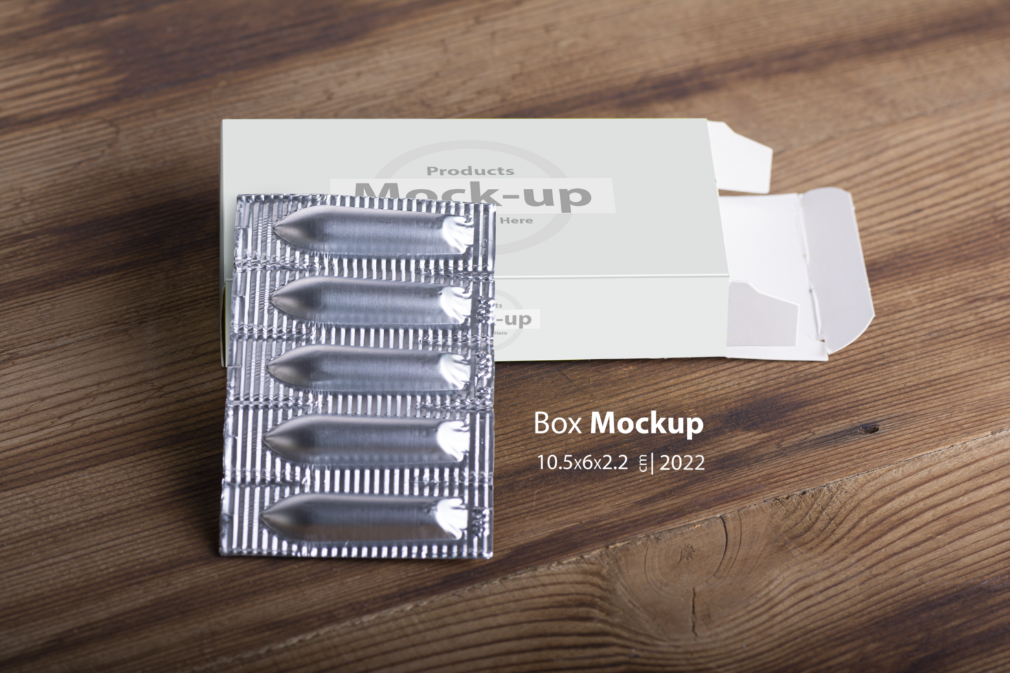 Suppositories loafs on an empty box on wooden table background psd