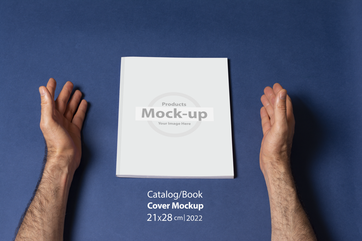 Male hands around a closed book-catalog with blank cover on blue background psd
