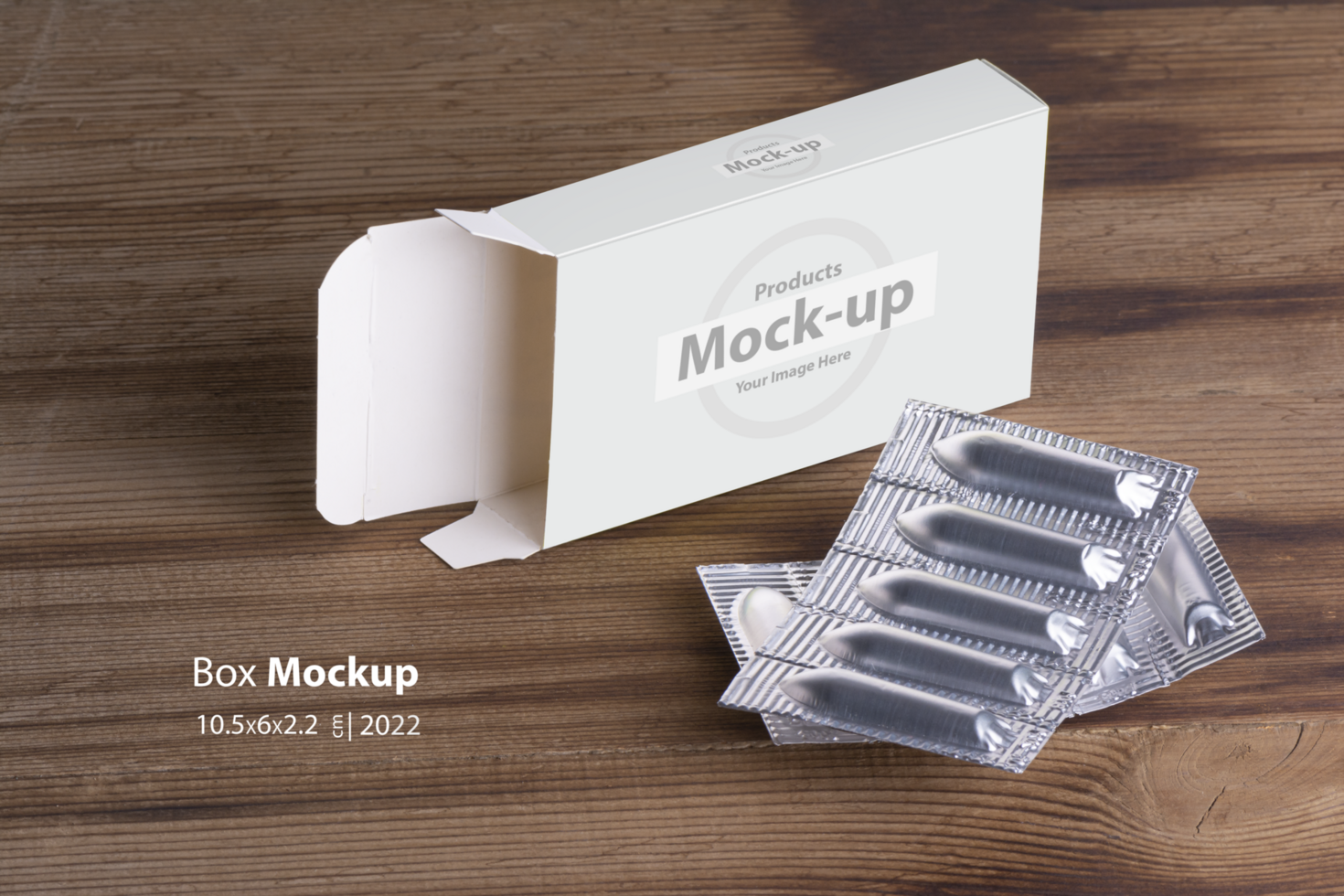 Suppositories loaf and an empty box on wooden table background psd