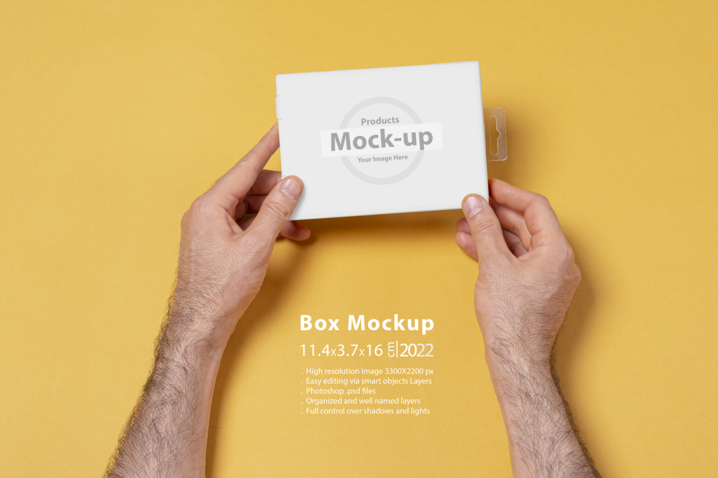 Male hands holding a small box in front of yellow background psd