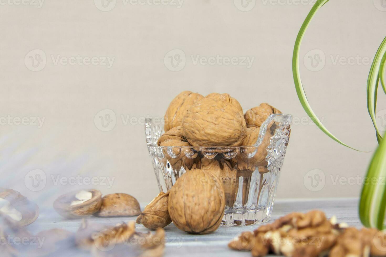 Walnuts in a shell in a crystal vase. Healthy nuts. photo