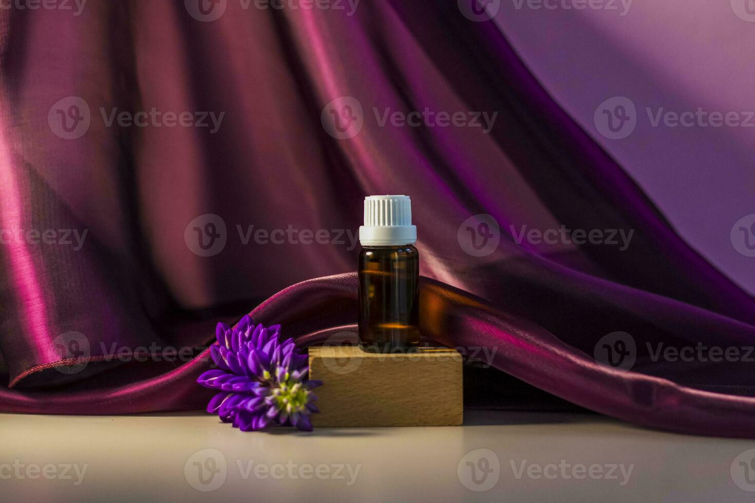 Bottle without label with oil on the stand. Transparent glass container with a dispenser on a beige-pink background. Product banner. Space for text, design. photo
