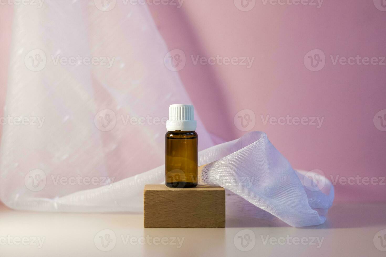 Bottle without label with oil on the stand. Transparent glass container with a dispenser on a beige-pink background. Product banner. Space for text, design. photo