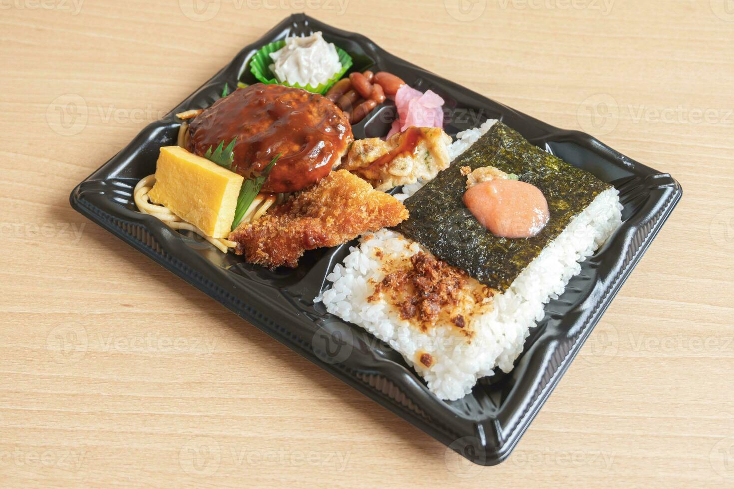 Japanese bento set lunch box of hamburger steak, seaweed on rice, fried fish and Japanese rolled omelet photo