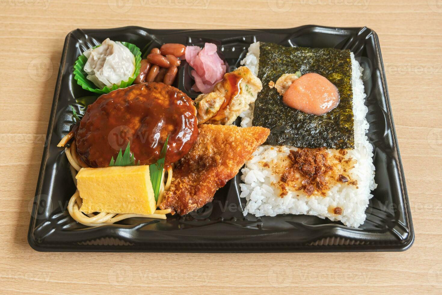 Japanese bento set lunch box of hamburger steak, seaweed on rice, fried fish and Japanese rolled omelet photo