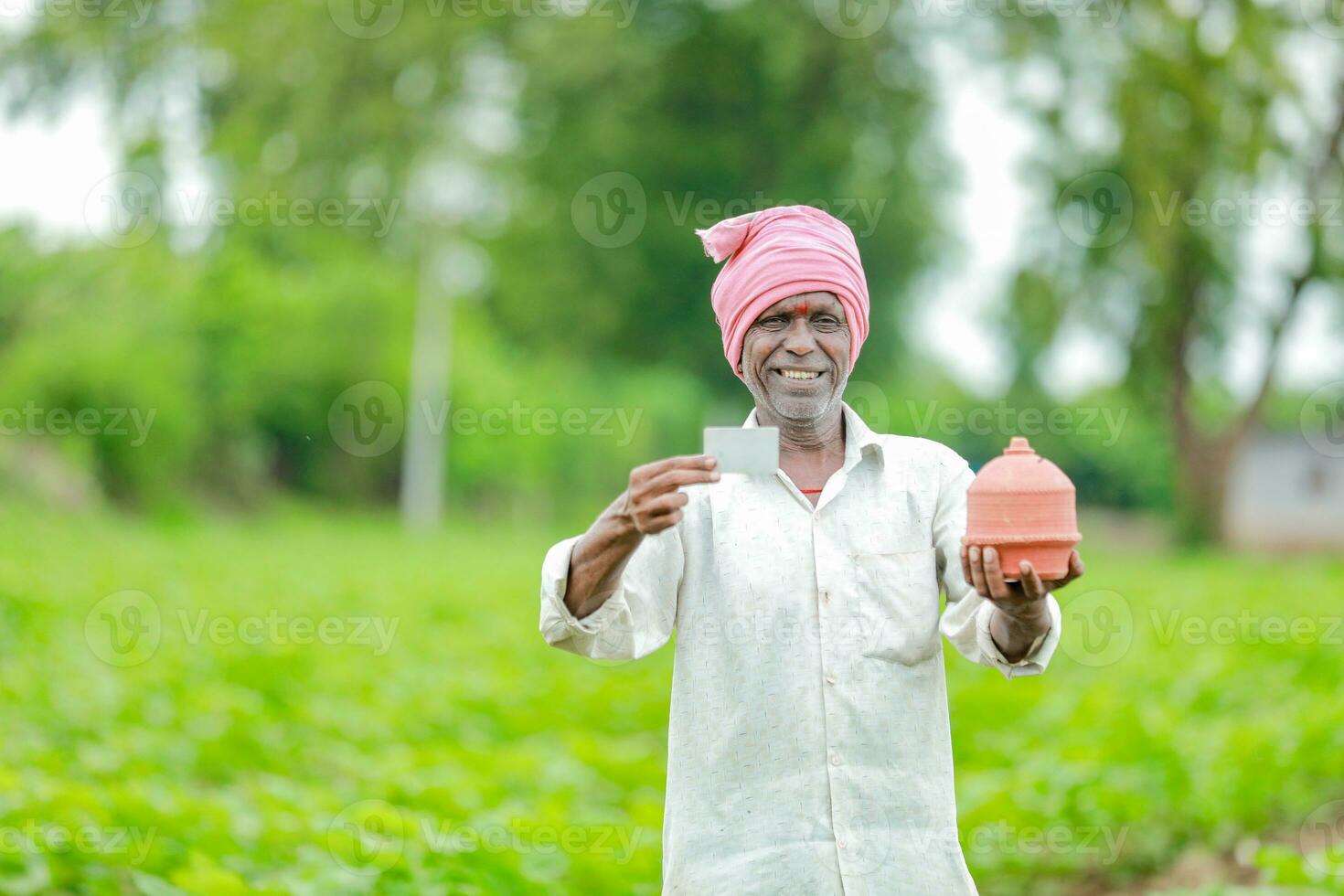 Indian farmer Holding gullak in hand, saving concept, happy poor farmer photo