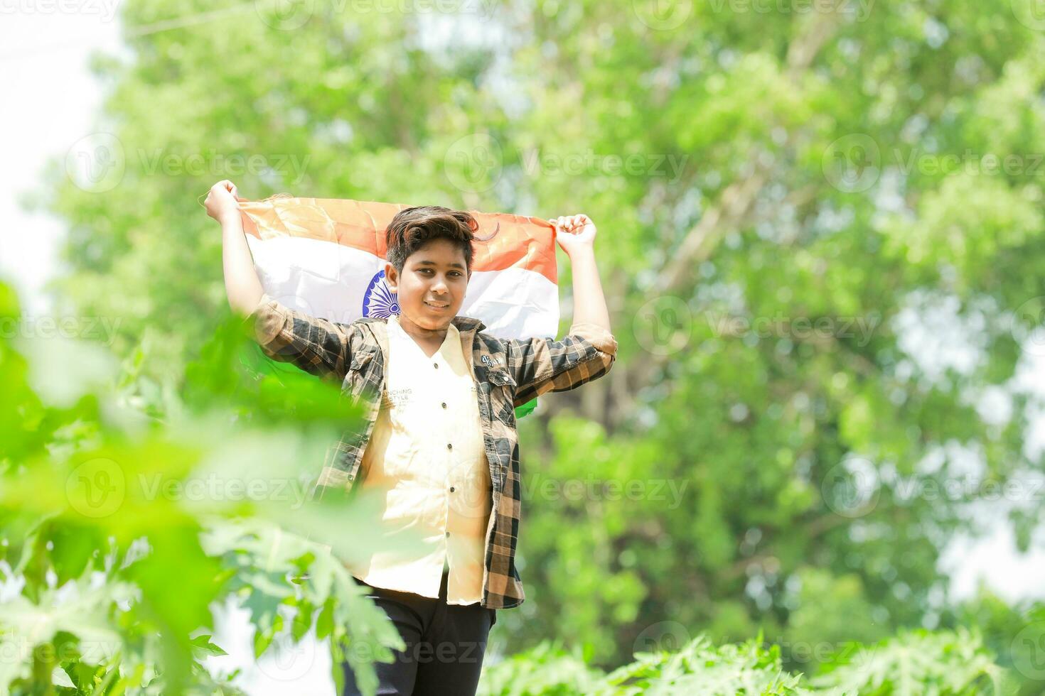 Indian boy holding national flag in farm, happy boy, national flag photo