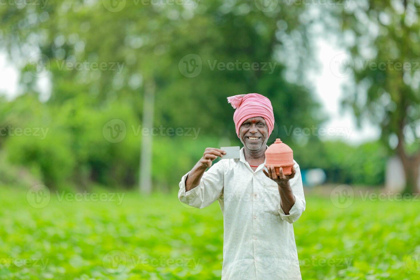 Indian farmer Holding gullak in hand, saving concept, happy poor farmer photo