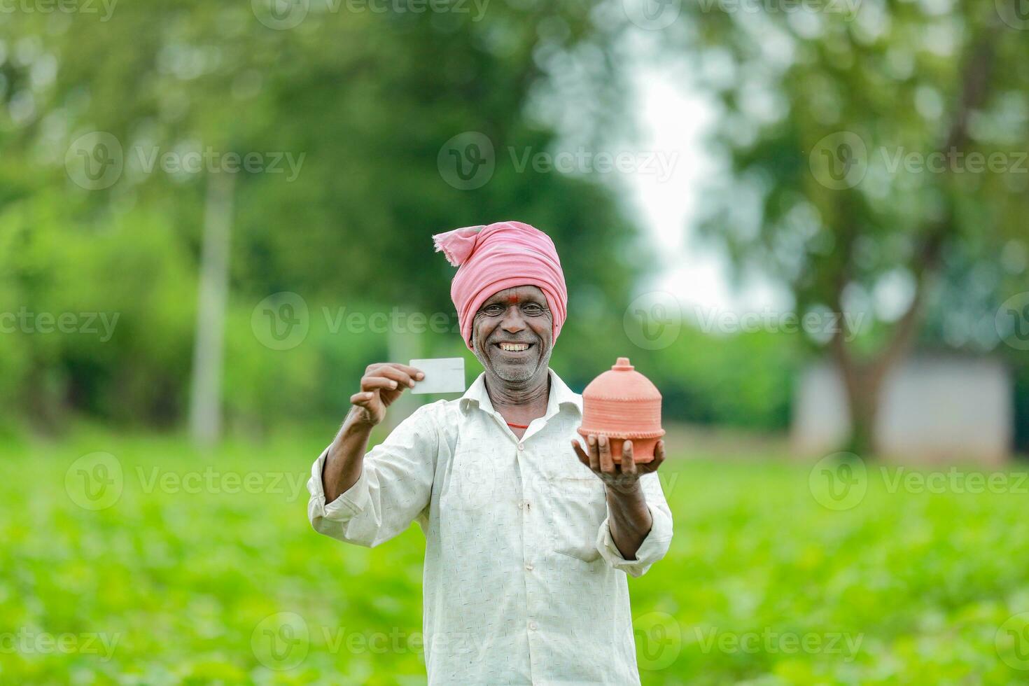 Indian farmer Holding gullak in hand, saving concept, happy poor farmer photo