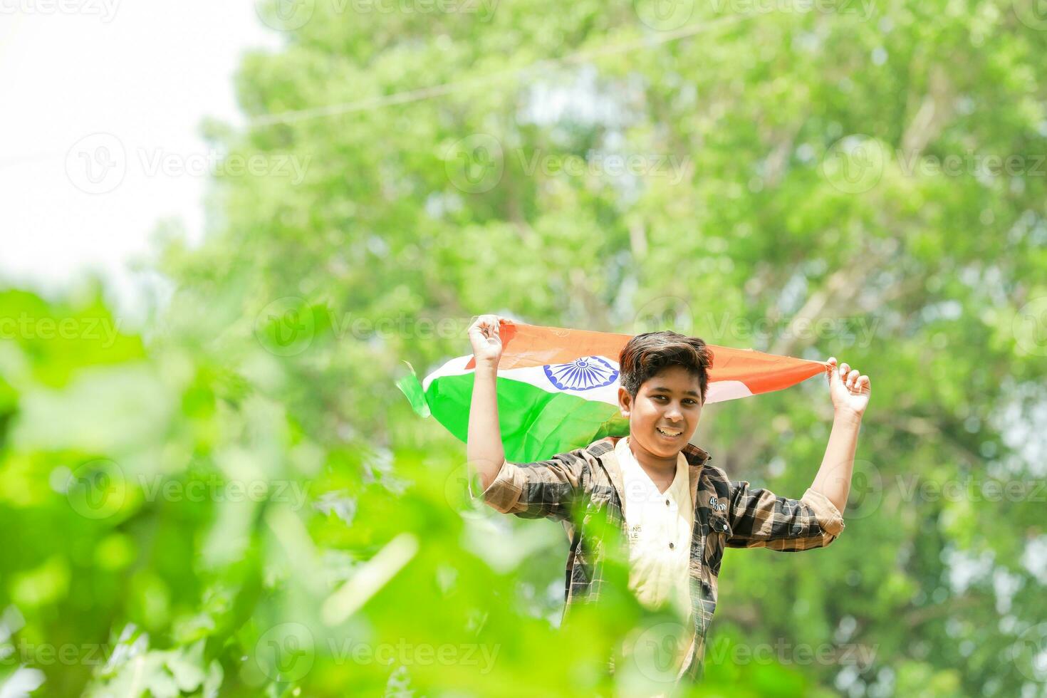 Indian boy holding national flag in farm, happy boy, national flag photo