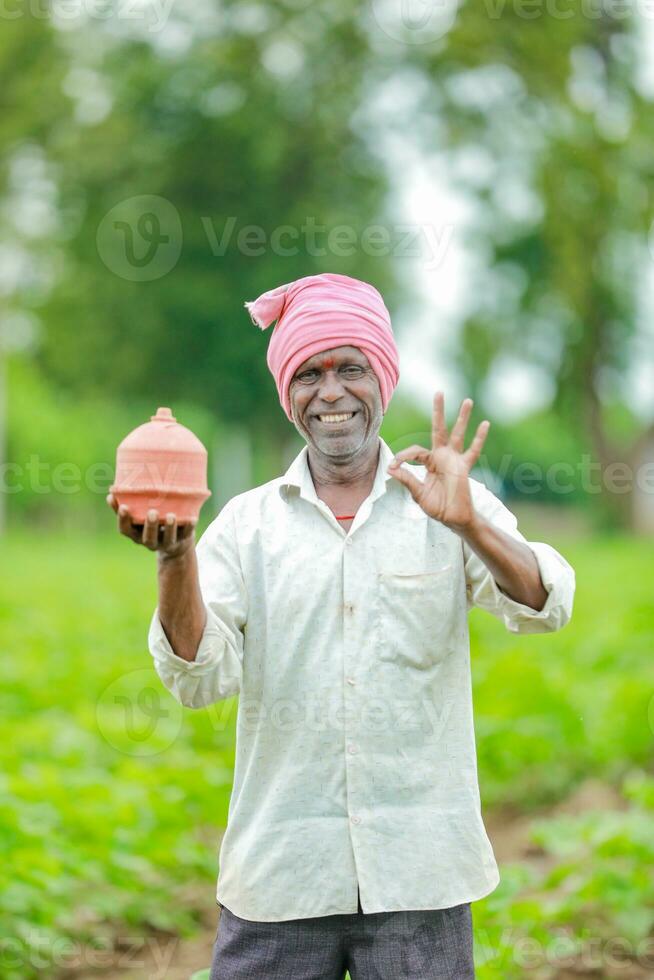 Indian farmer Holding gullak in hand, saving concept, happy poor farmer photo