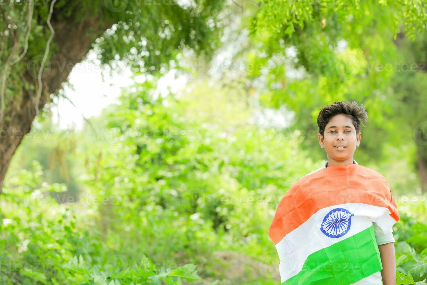 Indian boy holding national flag in farm, happy boy, national flag photo