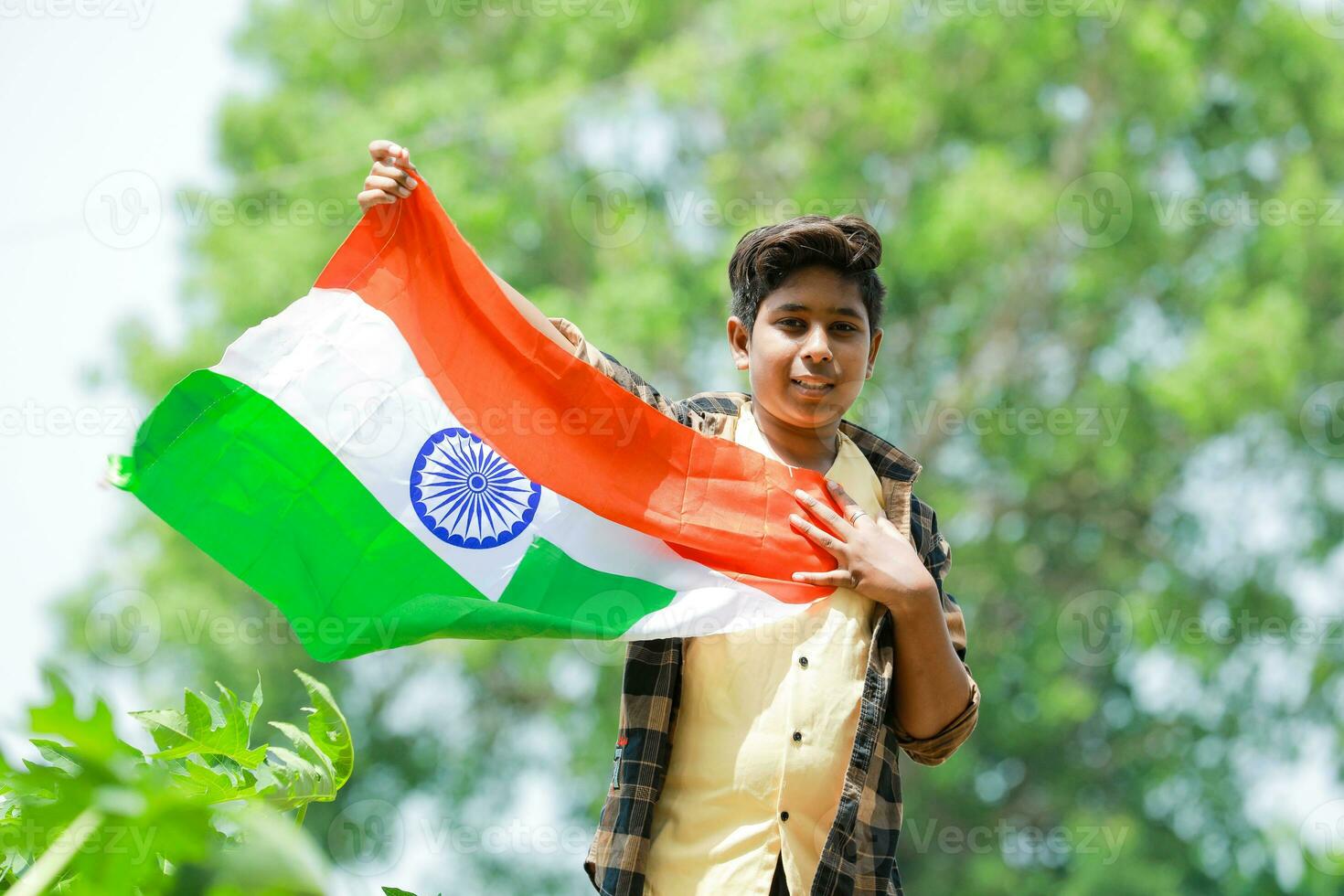 Indian boy holding national flag in farm, happy boy, national flag photo