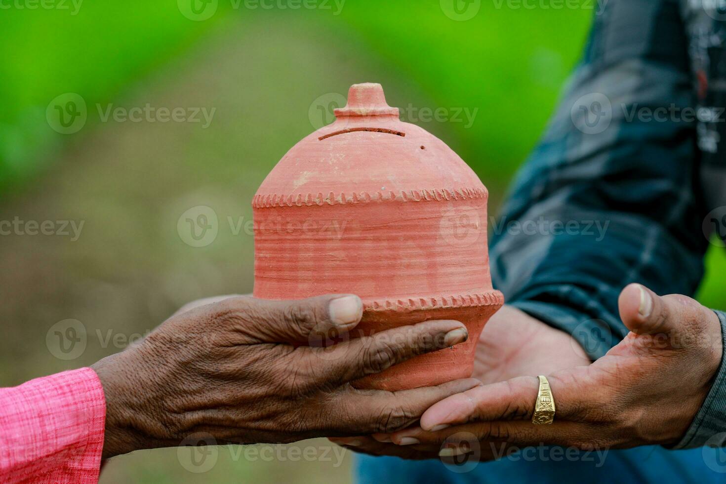 Indian farmer Holding gullak in hand, saving concept, happy poor farmer photo