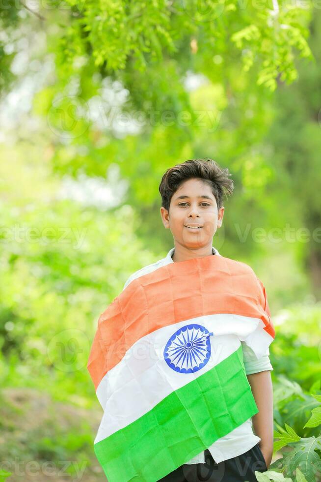 Indian boy holding national flag in farm, happy boy, national flag photo