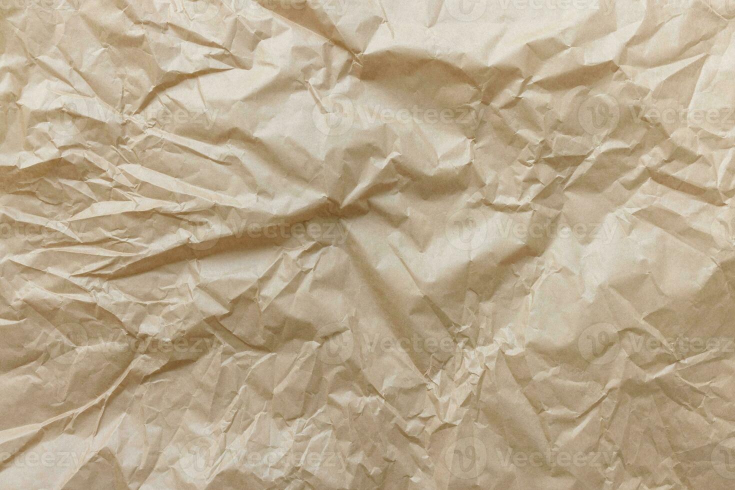 Crumpled used brown wrapping paper texture background photo