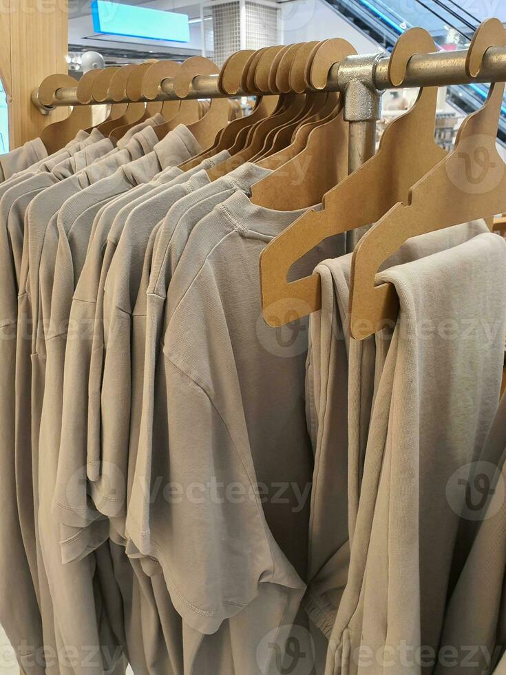 Casual gender neutral clothes on a rack in a store photo