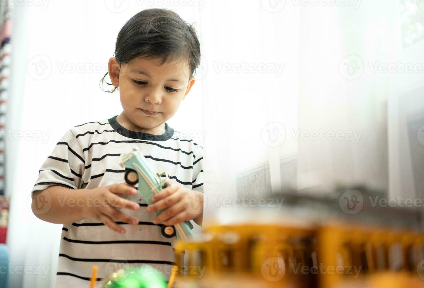 Baby boy playing with car toys Educational and creative toys and games for young children. Child at  home on the floor. photo