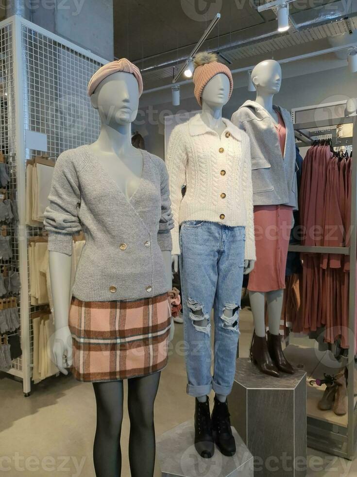 Showcase of woman clothes for fall winter on dummy photo