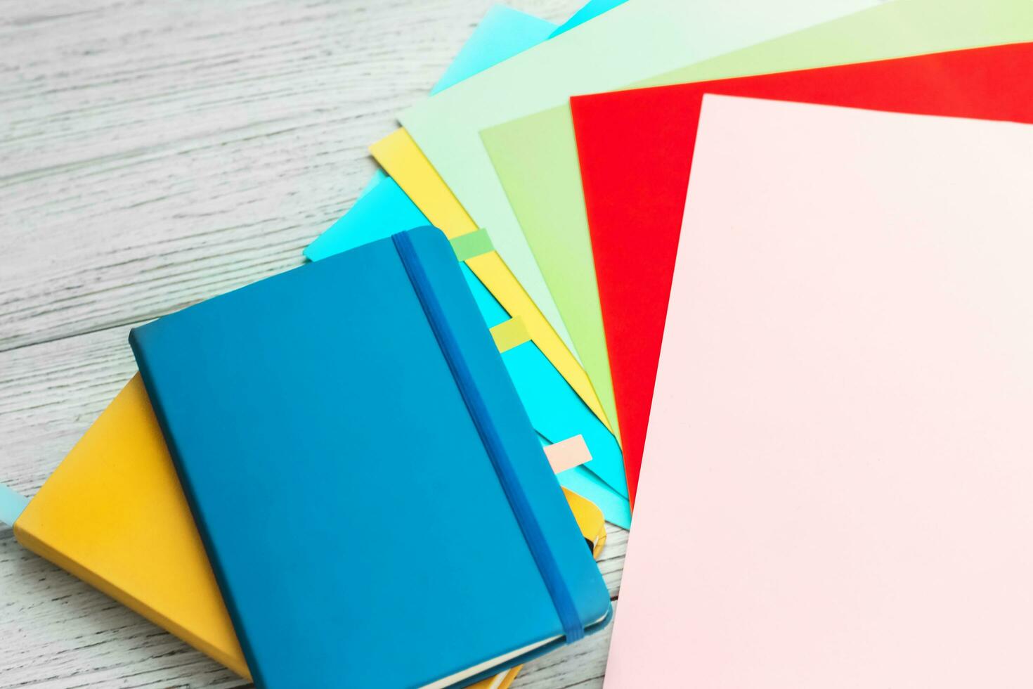 Notebook diary for planning in blue and yellow and colored cardboard for creativity. photo