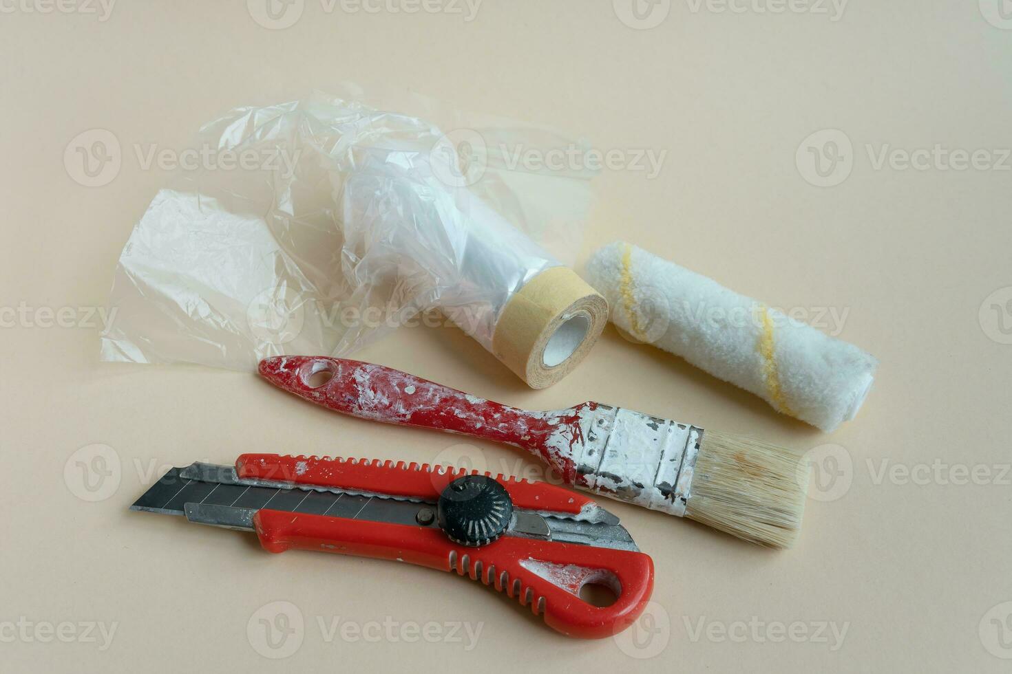 A set of painter's tools. a paint brush, a spatula and a knife for the builder. Masking tape. Handicraft photo