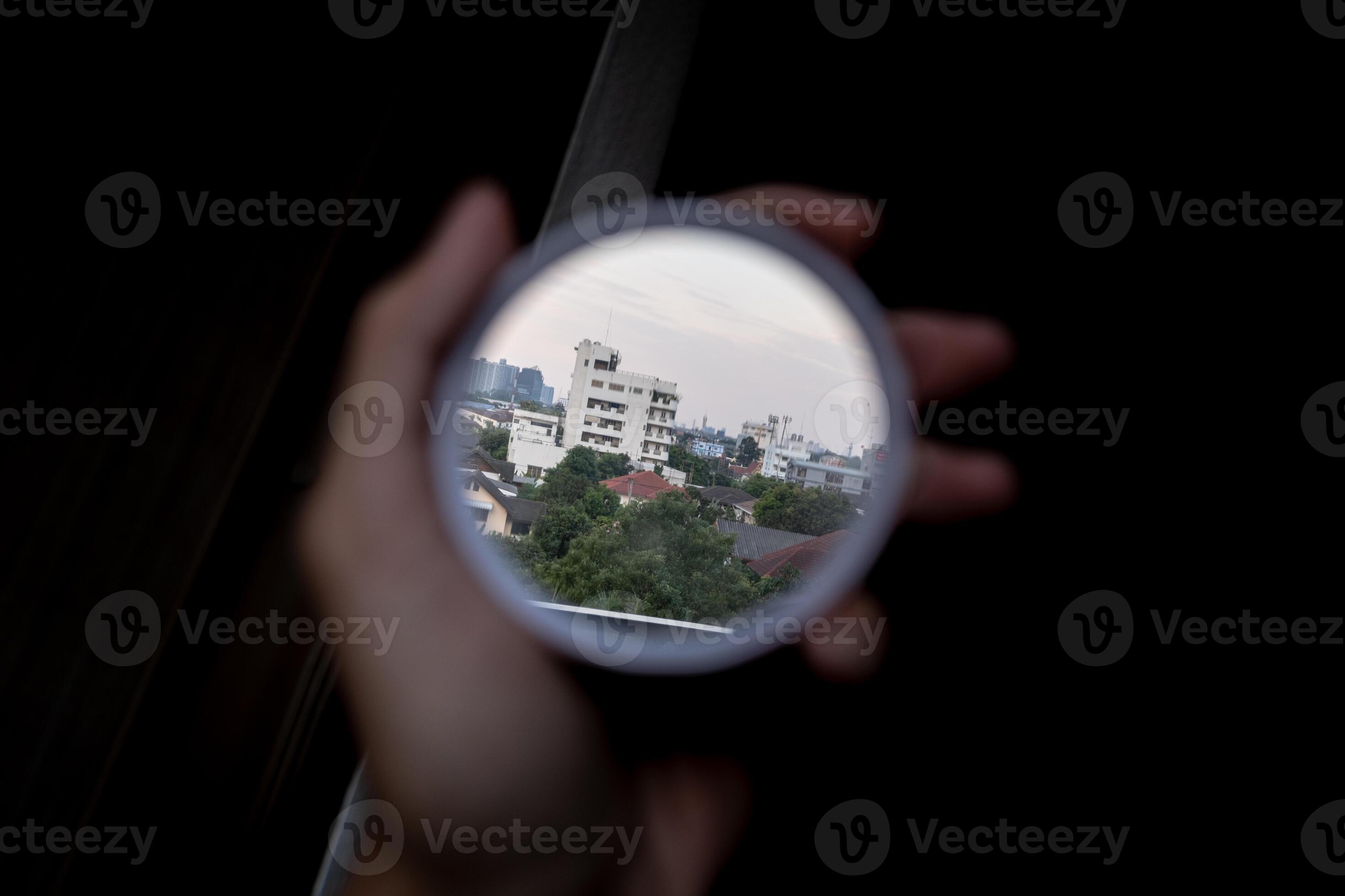 hand holding a small mirror that reflects the image backwards to see