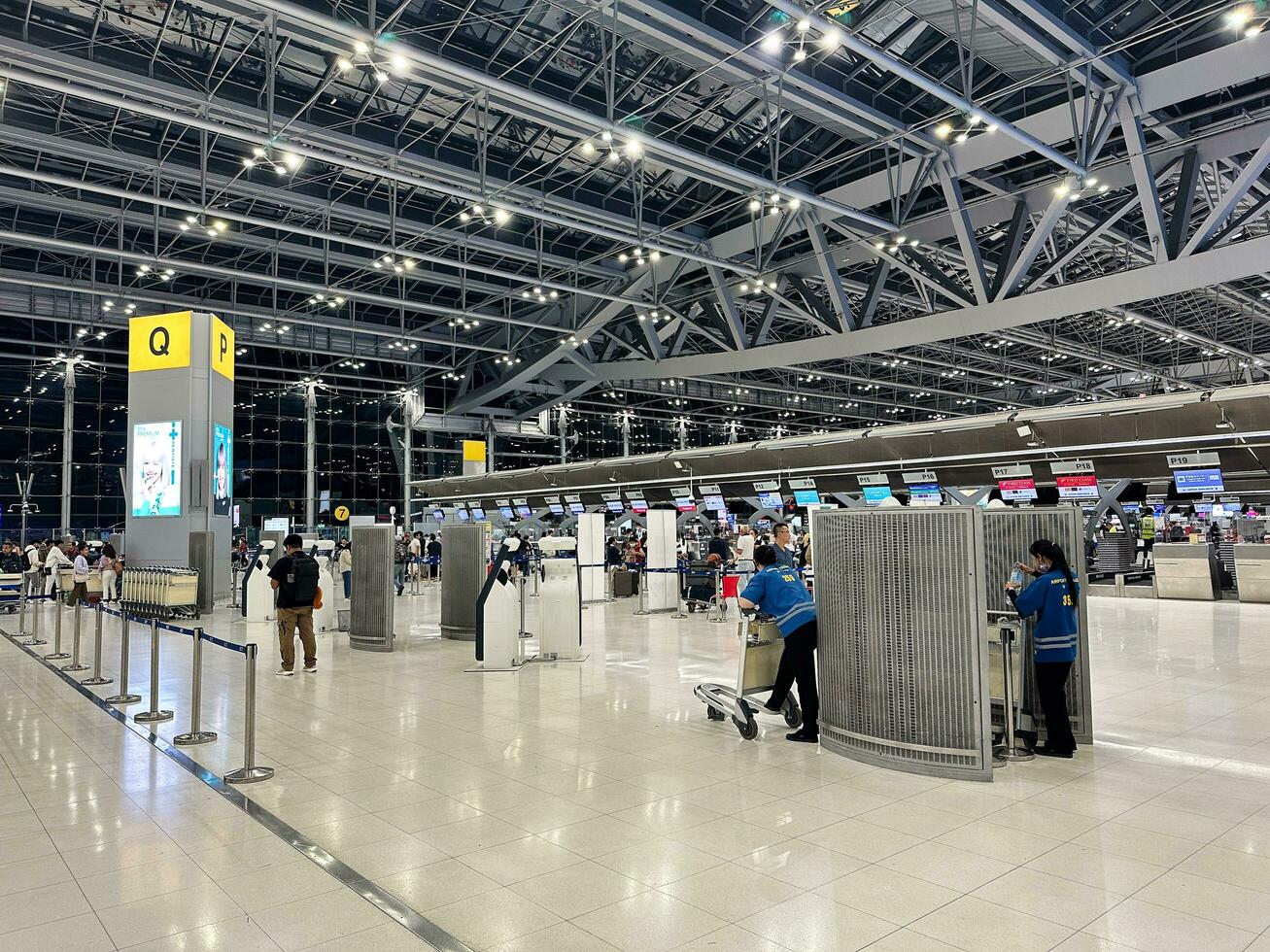 On July 10, 2023, sparse passengers and resting employees populate the check-in counter of a Bangkok airline, Suvarnabhumi Airport. photo