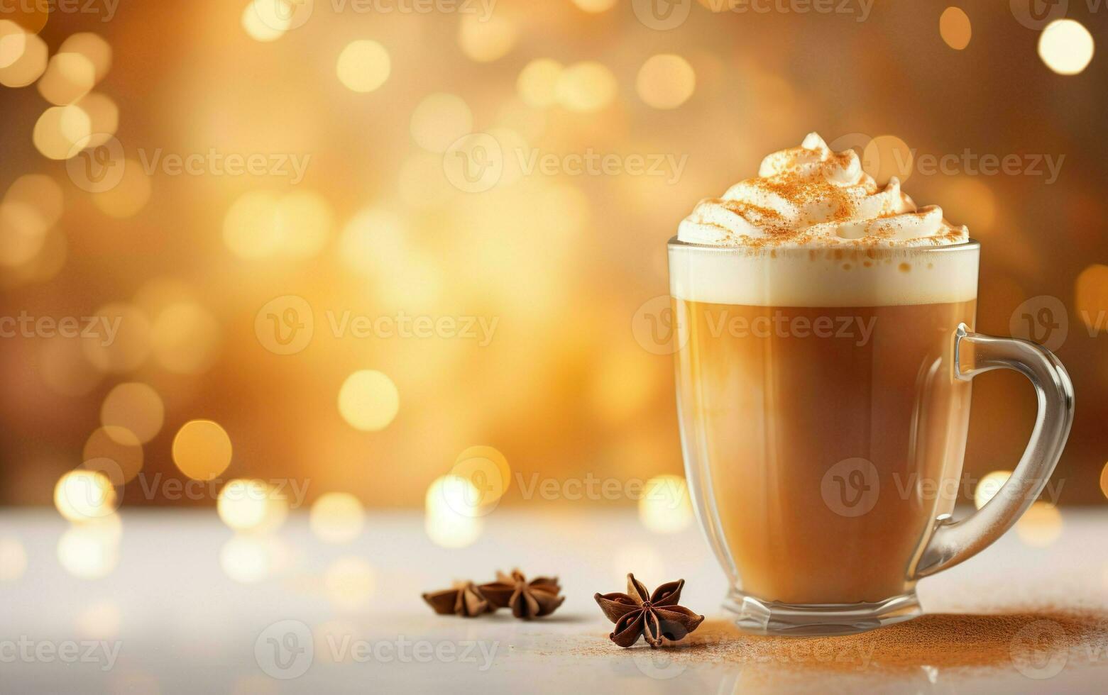 cup of coffee latte with whipped cream on, blurred sparkling gold background with beautiful bokeh, festive atmosphere,  star anise and cinnamon powder on the marble table photo