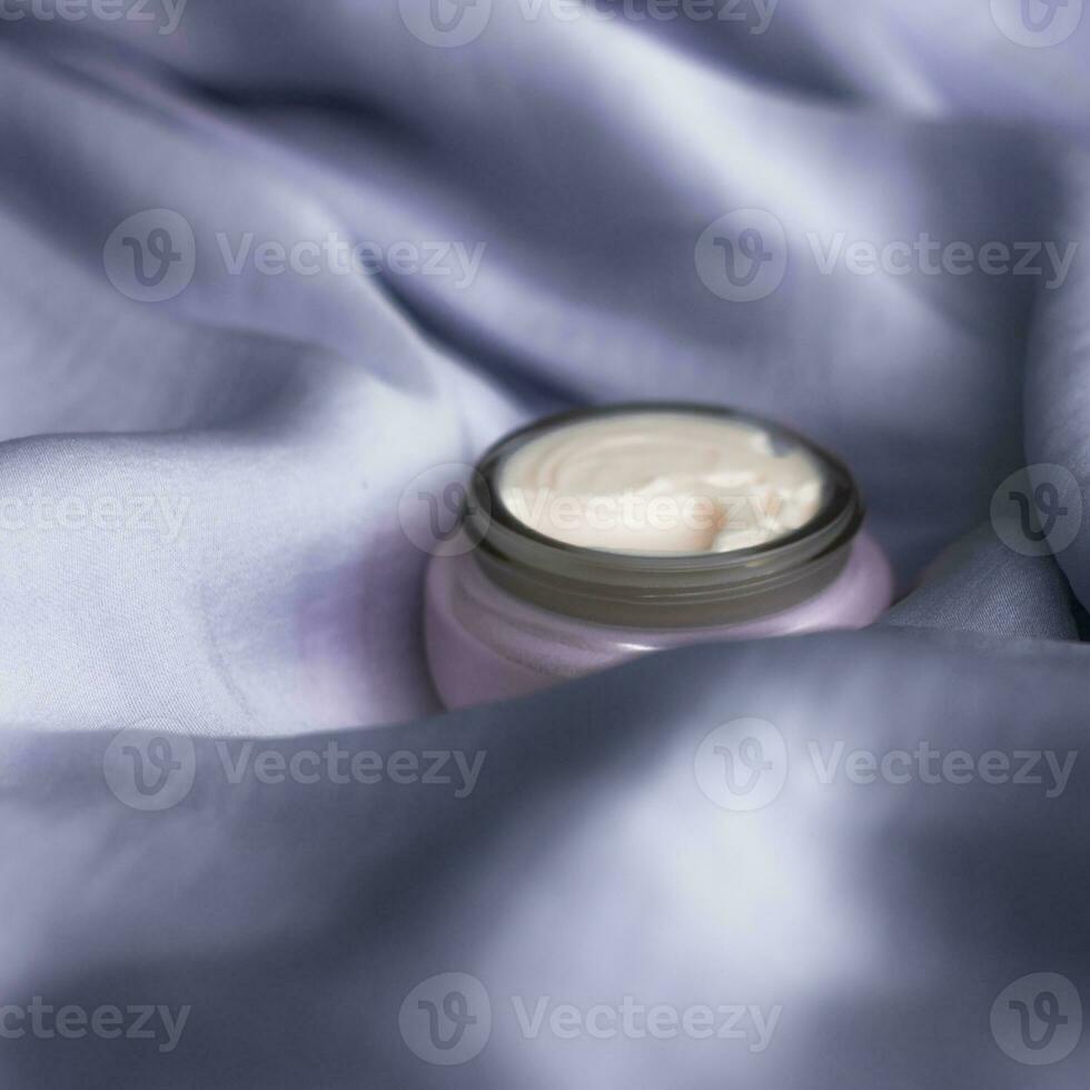 luxury face cream on soft silk - anti-aging, cosmetic and beauty styled concept photo