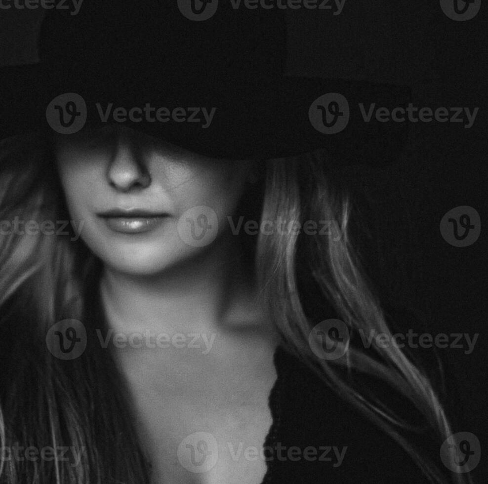 Beautiful blonde woman wearing a hat, artistic film portrait in black and white for fashion campaign and beauty brand photo