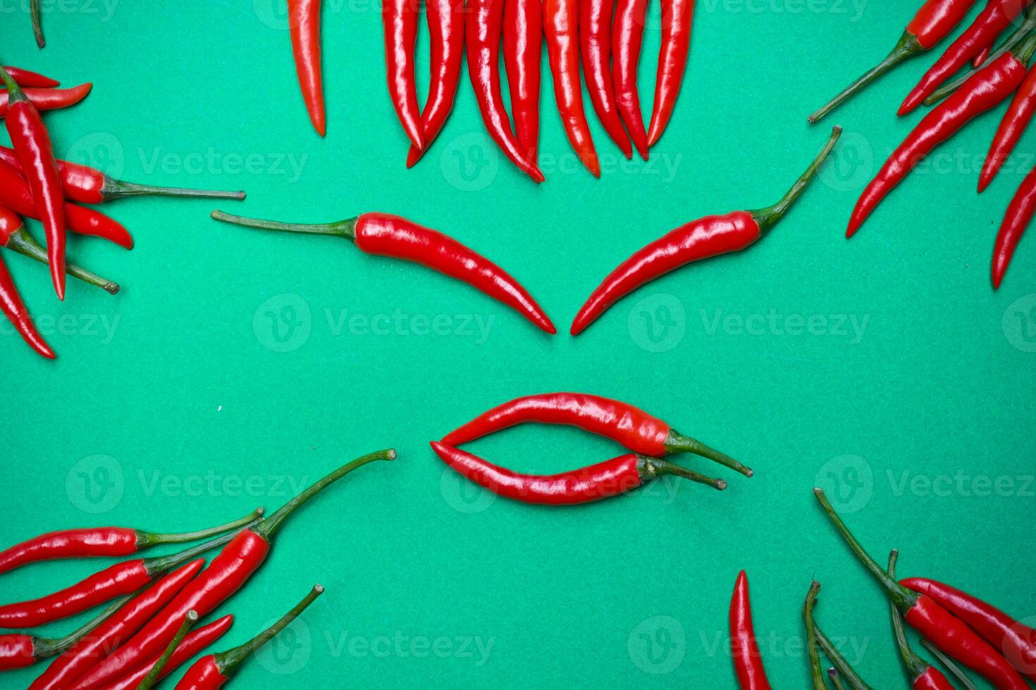 Spicy red chili on green background photo