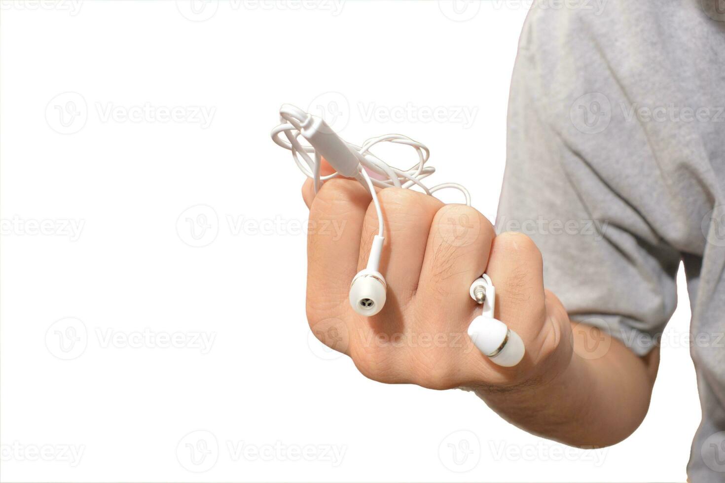 a man with tangled headphones in a twisted mess isolate white background photo