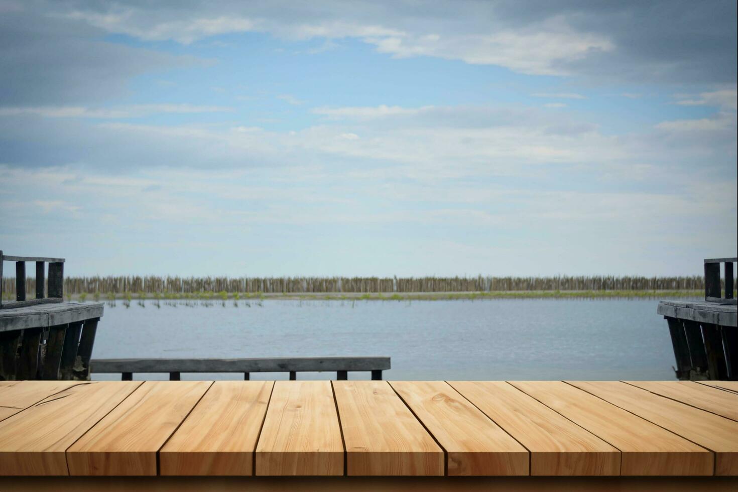 Wood board above empty table on sunset background. Brown wooden table can be used mock-up for display of montage products or key visual layout designs photo