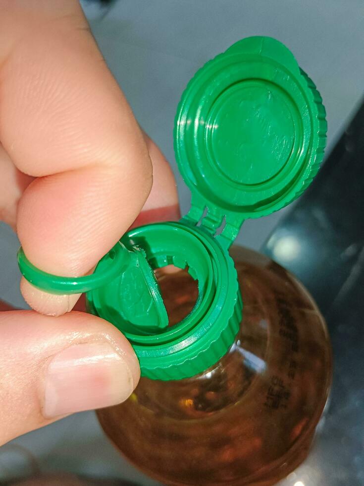 Open Cap Of Vegetable Oil Bottle Before Cooking photo