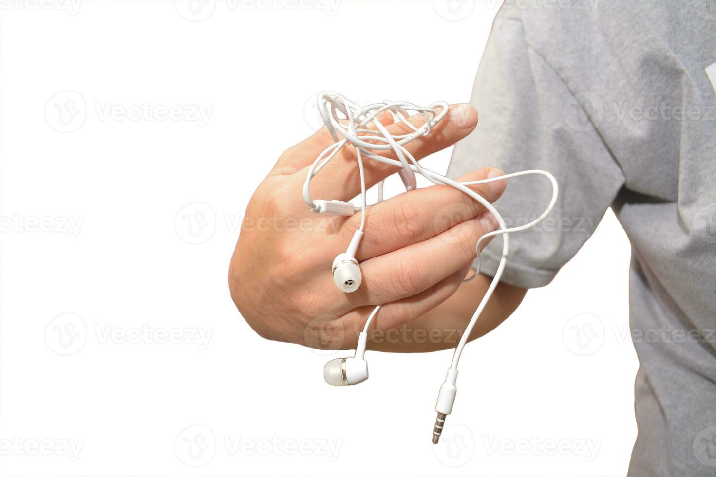 a man with tangled headphones in a twisted mess isolate white background photo