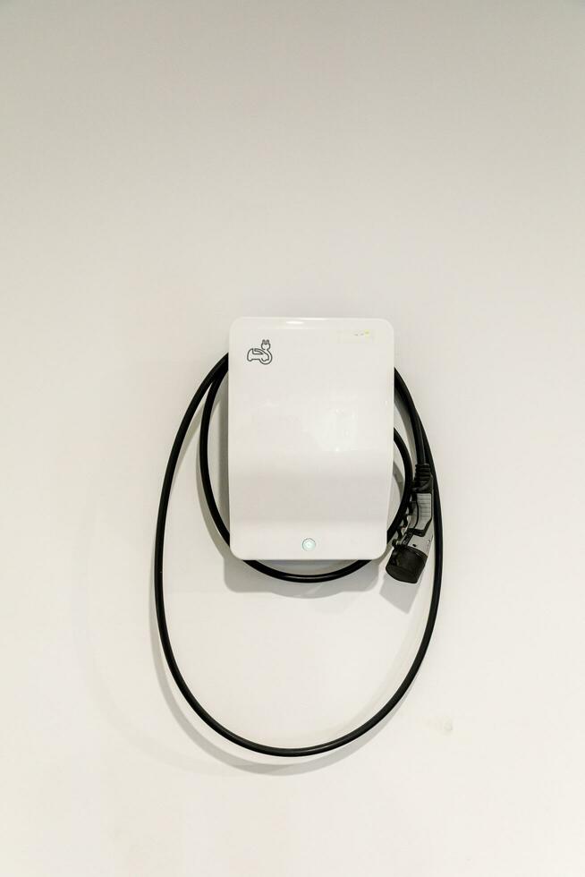 New charging station for electric car on wall at home, charging pillar with copy space , space for text photo
