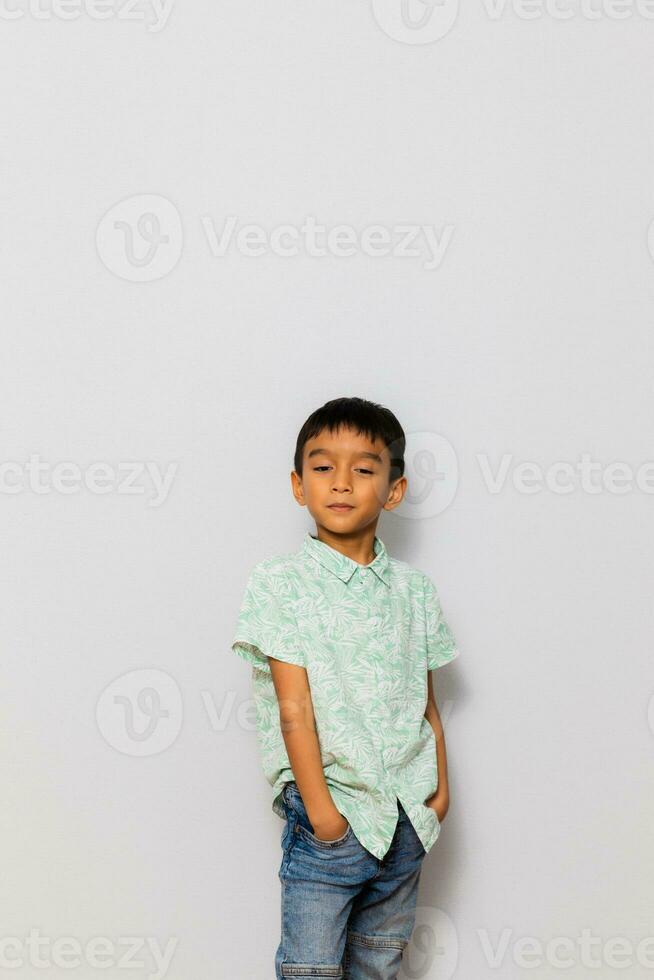 Cute little boy in casual outfit on background photo