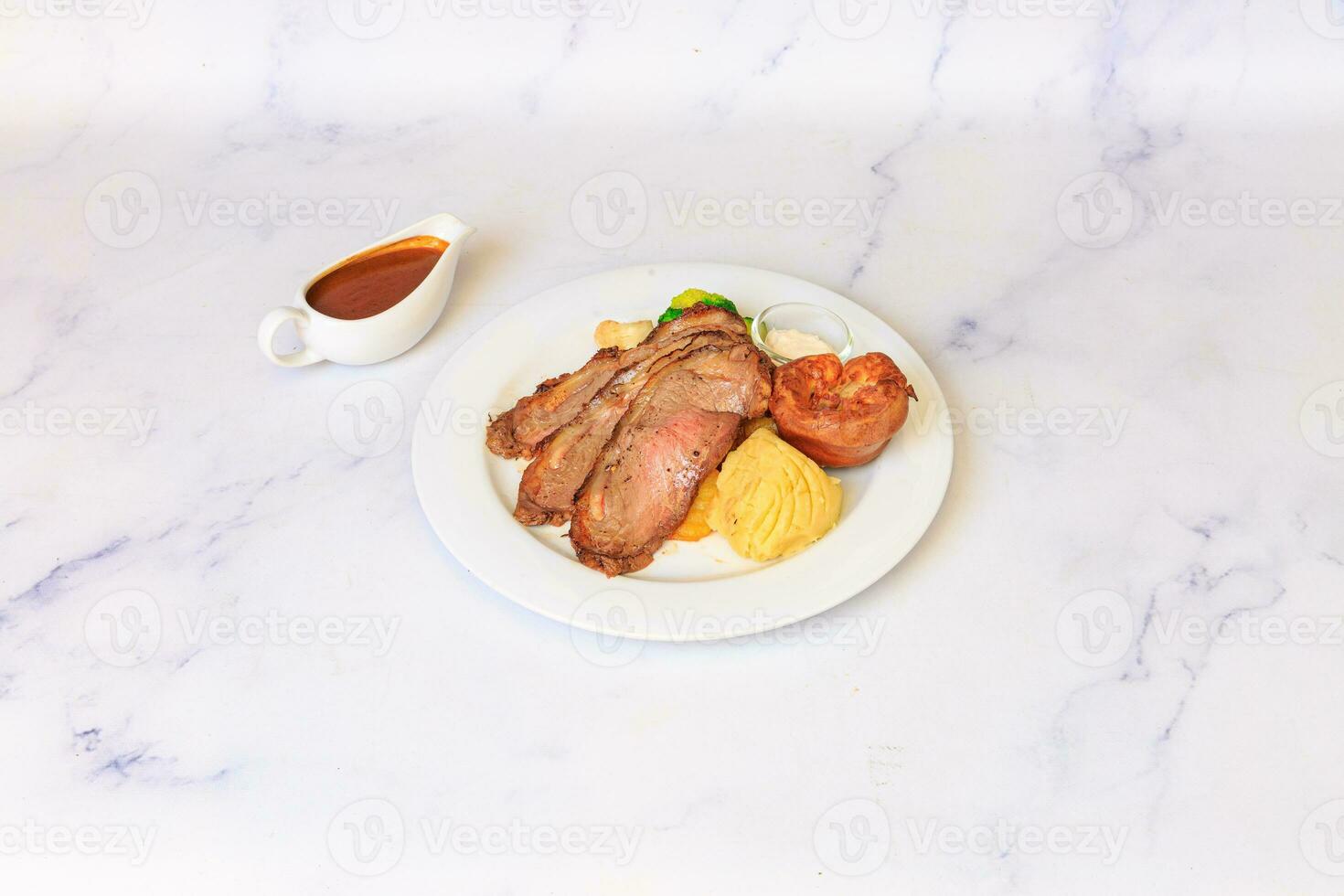 Beef Rendang. Grilled beef tenderloin steak on a dish with grilled vegetables. photo