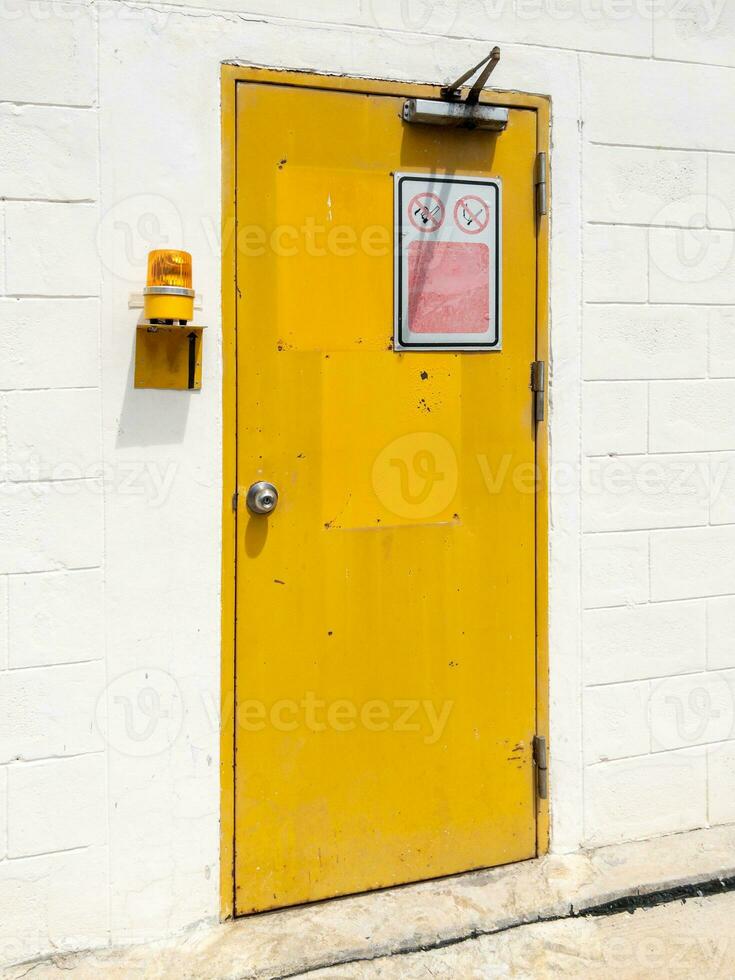 The yellow metal door with the door closes. photo