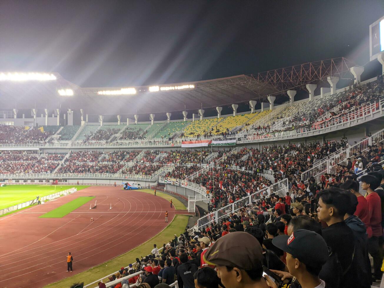 Surabaya, indonesia - 22 june 2023 - A view and atmosphere with many indonesia supporter at gelora bung tomo. Indonesia vs palestina friendly match. photo